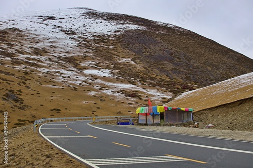 Highway on the high mountain with some cover of snow in China