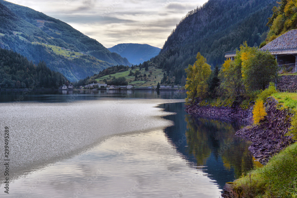 beautiful view of a mountain lake in the autumn sunny day.