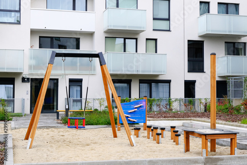 layground with a children swing in cozy courtyard of modern residential district.