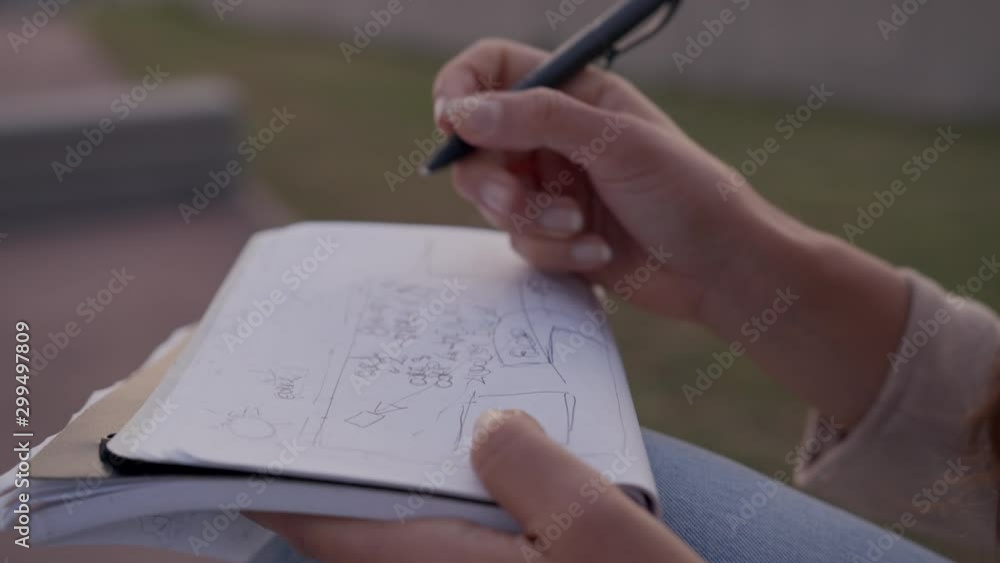 Slow-motion Detail shot of a Woman Entrepreneur handwriting after work and taking notes Close Up medium shot on a city Slow-motion Detail shot of a Woman Entrepreneur handwriting after work and taking notes Close Up medium shot on a city