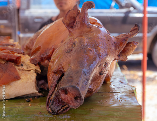 Grilled pork head, Filipino national food. Whole pig barbecue. Pork roasted with crispy skin. Philippine fiesta food. photo