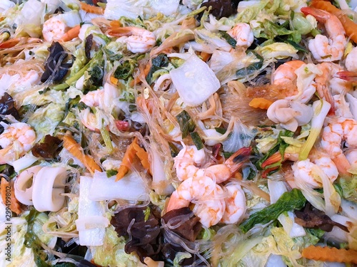 Thai food style, Top view of fried vermicelli noodle with shrimp and mixed vegetable as a background, This food is most popular Thai food (pad vunsen), Ready to eat or serve