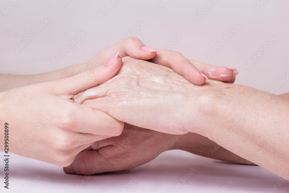 Fototapeta premium hands of a young woman doing massage on the hands of an elderly woman