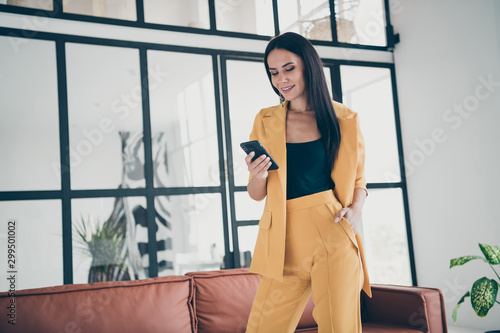Portrait of her she nice-looking attractive charming cheerful lady using 5g app digital device launching start-up in modern style interior glass room flat house home indoors