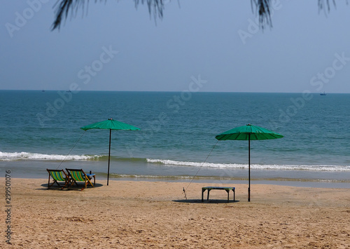 Beach chairs and colorful umbrella on the beach in sunny day,