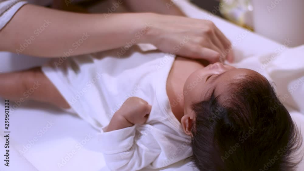 4k Asian parent put on clothes for infant baby girl after a bath at home, warm and happy, cozy, robe, baby lying down on a table, fluorescent light, day time, clean hygiene, anti bacteria, black hair 4k Asian parent put on clothes for infant baby girl after a bath at home, warm and happy, cozy, robe, baby lying down on a table, fluorescent light, day time, clean hygiene, anti bacteria, black hair