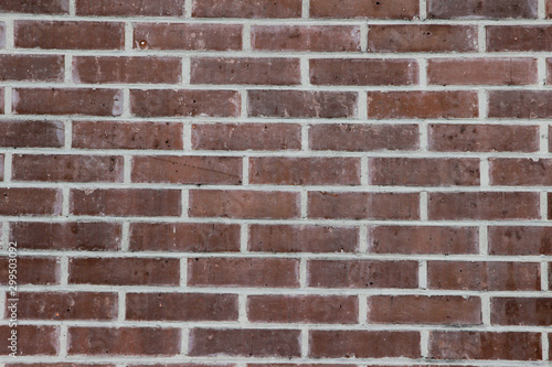 Texture of a red brick wall laid with white cement as a background