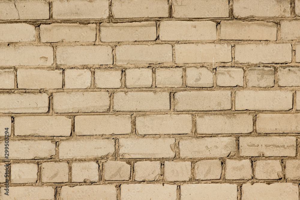Texture of a brick wall coated with beige paint Texture of a brick wall coated with beige paint