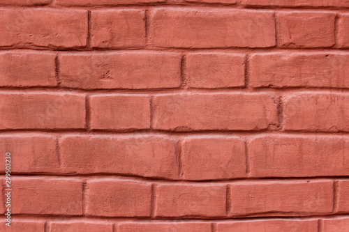 Texture of a brick wall coated with red paint