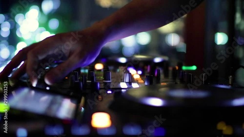 DJ's hand mixing music in the night party photo