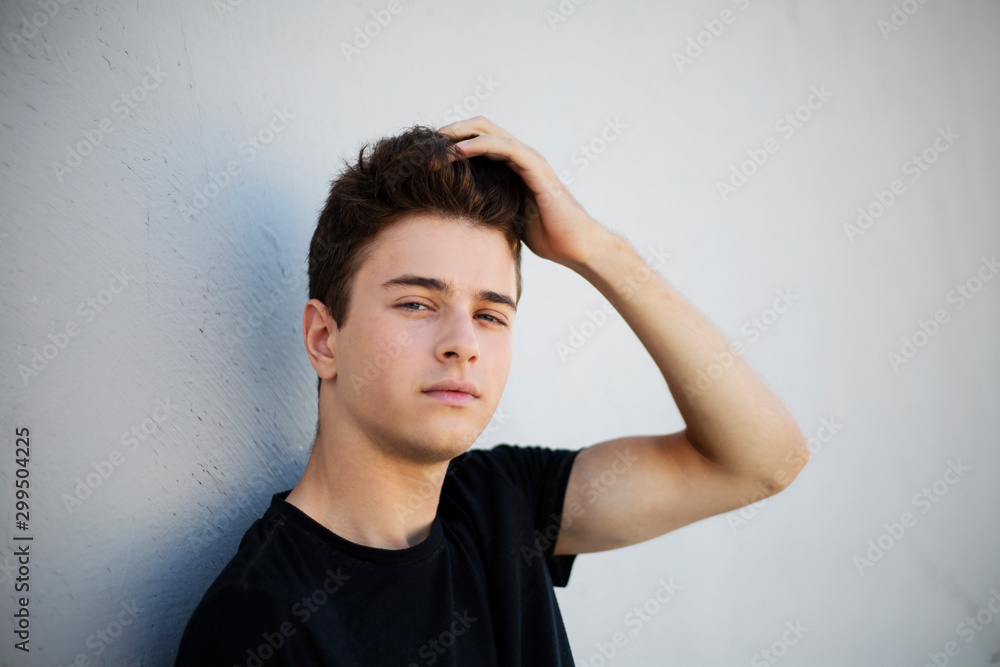 Young attractive man posing in front of camera in a black t-shirt Young attractive man posing in front of camera in a black t-shirt