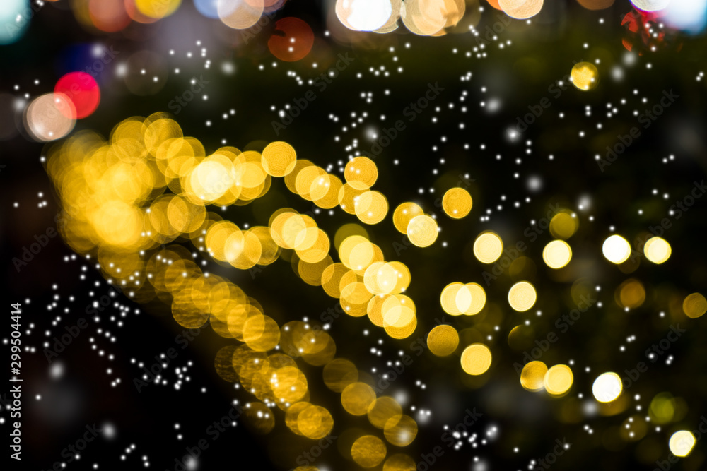 Colorful orange bokeh with snow background of Christmas lights and New year