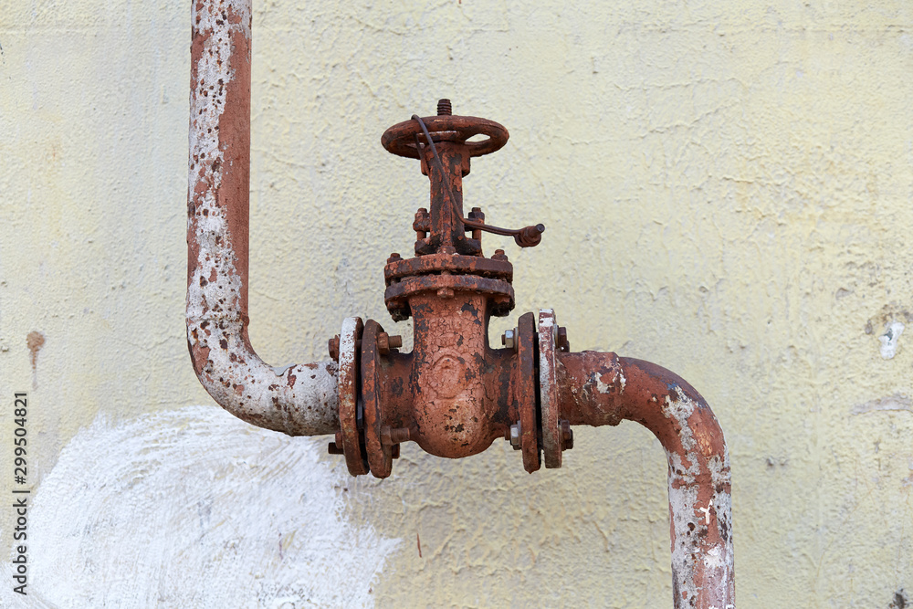 Valve on the gas pipe on the wall background. Valve on the gas pipe on the wall background.