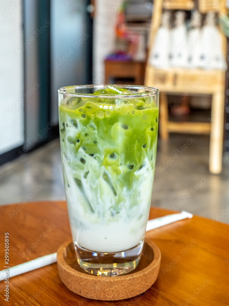 Iced green tea with milk in glass in coffee shop Iced green tea with milk in glass in coffee shop