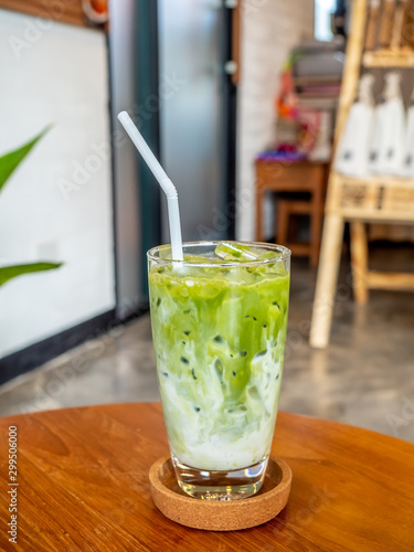 Iced green tea with milk in glass in coffee shop