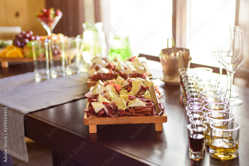 Сatering table with food and glass stemware at restaurant before party Сatering table with food and glass stemware at restaurant before party