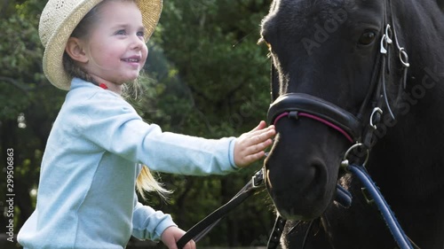 Wallpaper Mural Little girl and black pony in park Torontodigital.ca