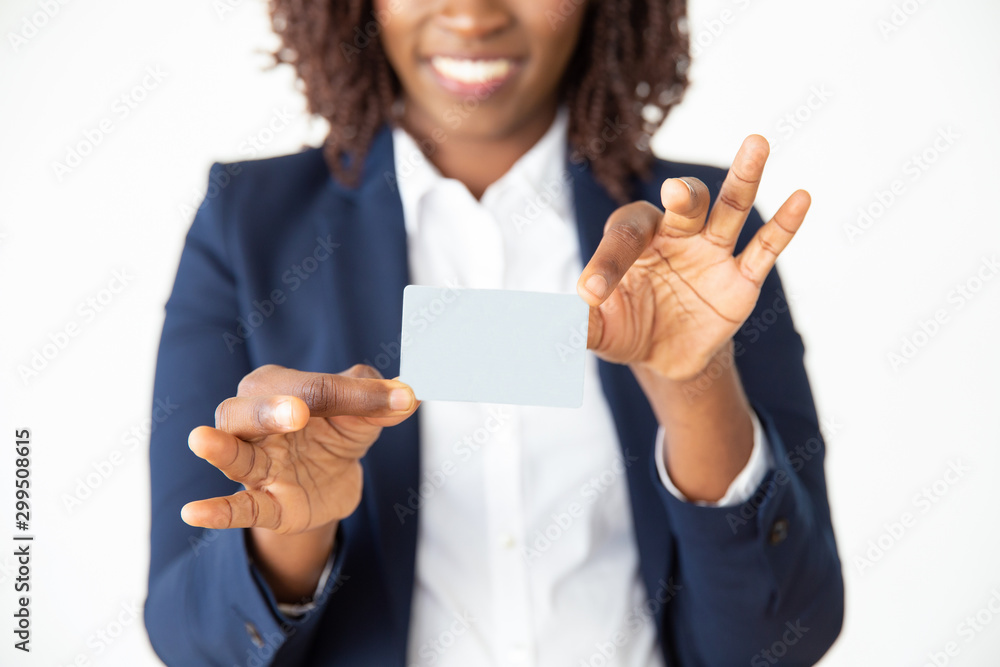 Smiling female professional holding blank plastic card. Young African American business woman standing isolated over white background. Credit card or payment concept Smiling female professional holding blank plastic card. Young African American business woman standing isolated over white background. Credit card or payment concept