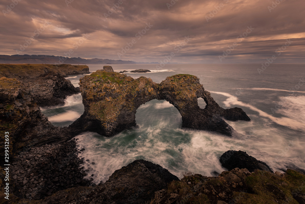 Gatklettur arch in Arnarstapi town in Snæfellsnes peninsula, West Iceland. Gatklettur arch in Arnarstapi town in Snæfellsnes peninsula, West Iceland.