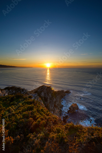 Asturias, sunset on the beach from a cliff in the Cantabrian Sea near Cudilleros.