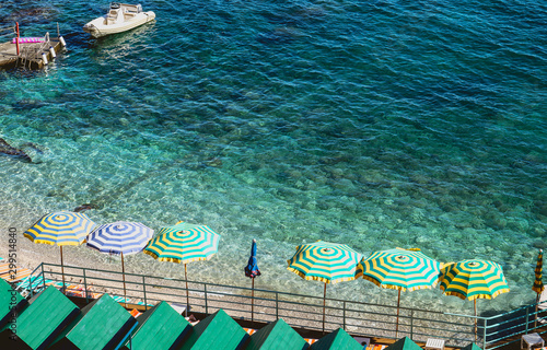group of umbrellas placed on the shore of the beach in Capri Island Italy