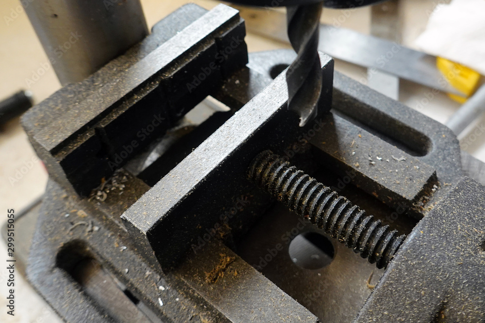 Old vice and drill bit close up. Selective focus. Old vice and drill bit close up. Selective focus.