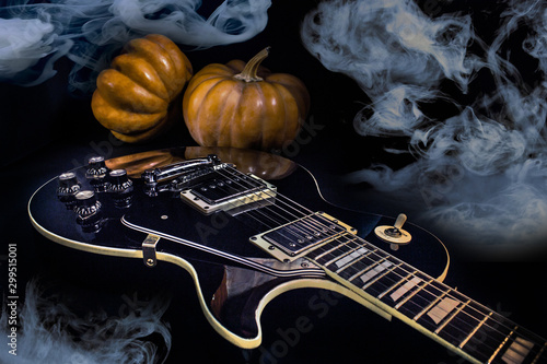 black patent electric guitar, smoke and pumpkins, halloween concept