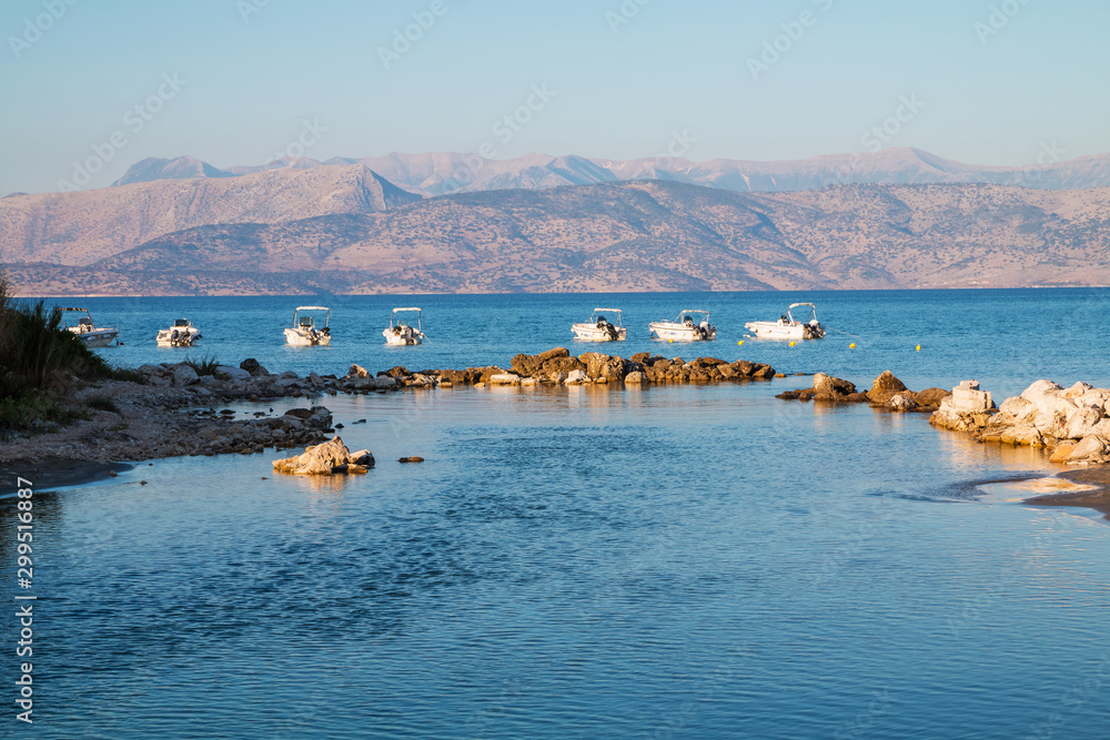 Fototapeta premium Panoramic view at hills of Albania. View from Corfu Island in Greece. Motor boats in background