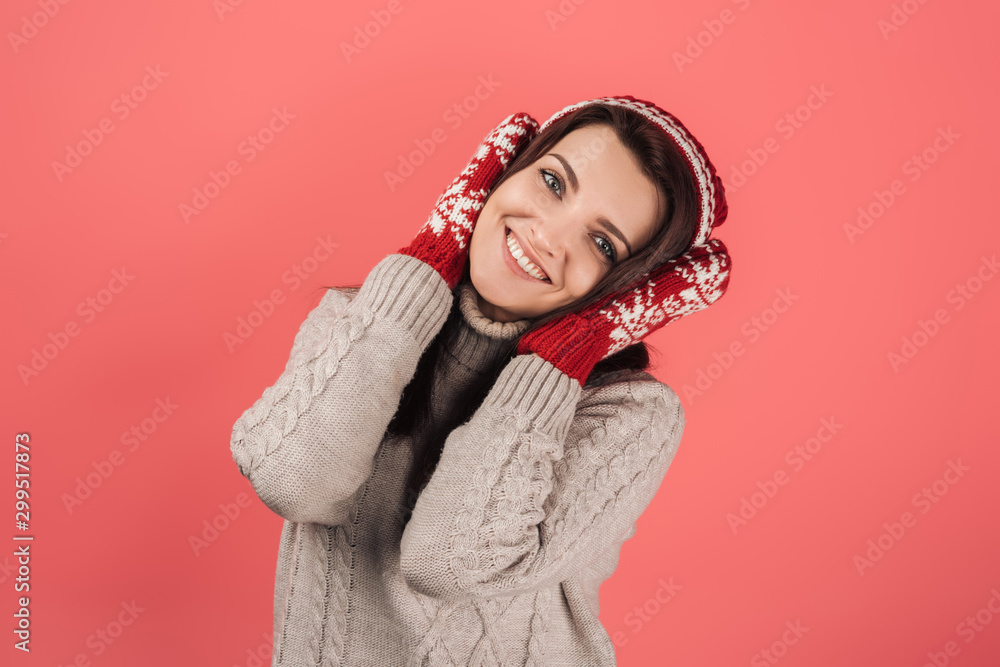 positive woman in knitted hat and gloves covering ears isolated on pink positive woman in knitted hat and gloves covering ears isolated on pink