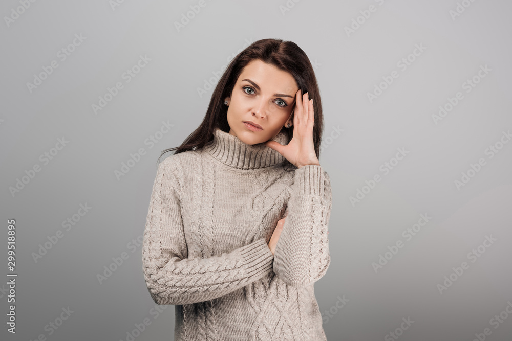 attractive woman with headache looking at camera isolated on grey attractive woman with headache looking at camera isolated on grey