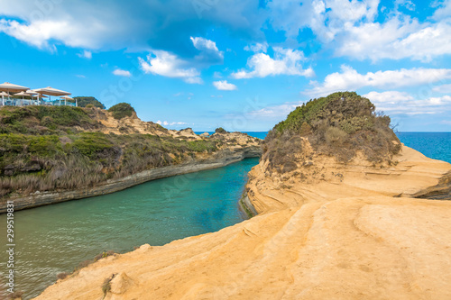 Colorful spring view of famous Channel Of Love (Canal d'Amour) beach. Bright morning seascape of Ionian Sea. Amazing outdoor scene of Corfu Island, Greece, Europe. Beauty of nature concept background