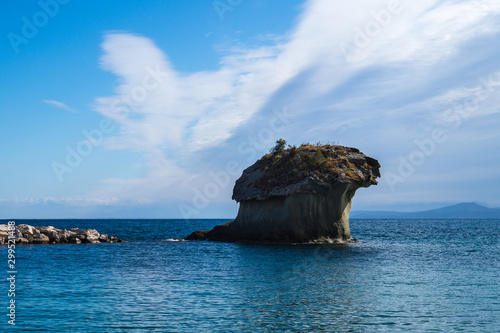 Famous coastal mushroom shaped rock Il Fungo. Lacco Ameno resort town, Ischia island, Italy