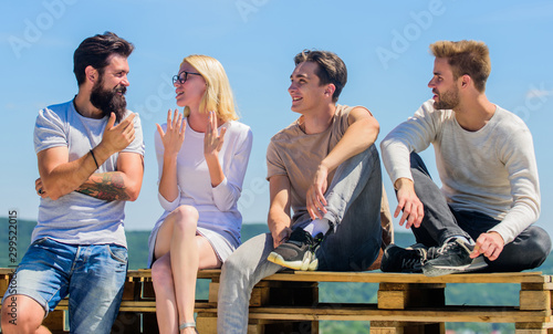 Always happy together. happy men and girl relax. best friends. Summer vacation. diverse young people talking together. group of four people. great fit for day off. Group of people in casual wear