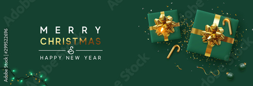 Holiday background Merry Christmas and Happy New Year. Xmas design with realistic festive objects, sparkling lights garland, green gift box, ball bauble, glitter gold confetti. Horizontal banner
