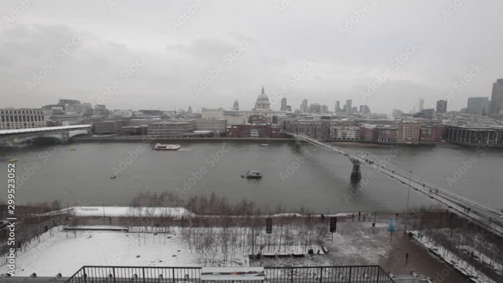 Millennium Bridge Over Thames River at Cloudy Winter Day in London Snow Millennium Bridge Over Thames River at Cloudy Winter Day in London Snow