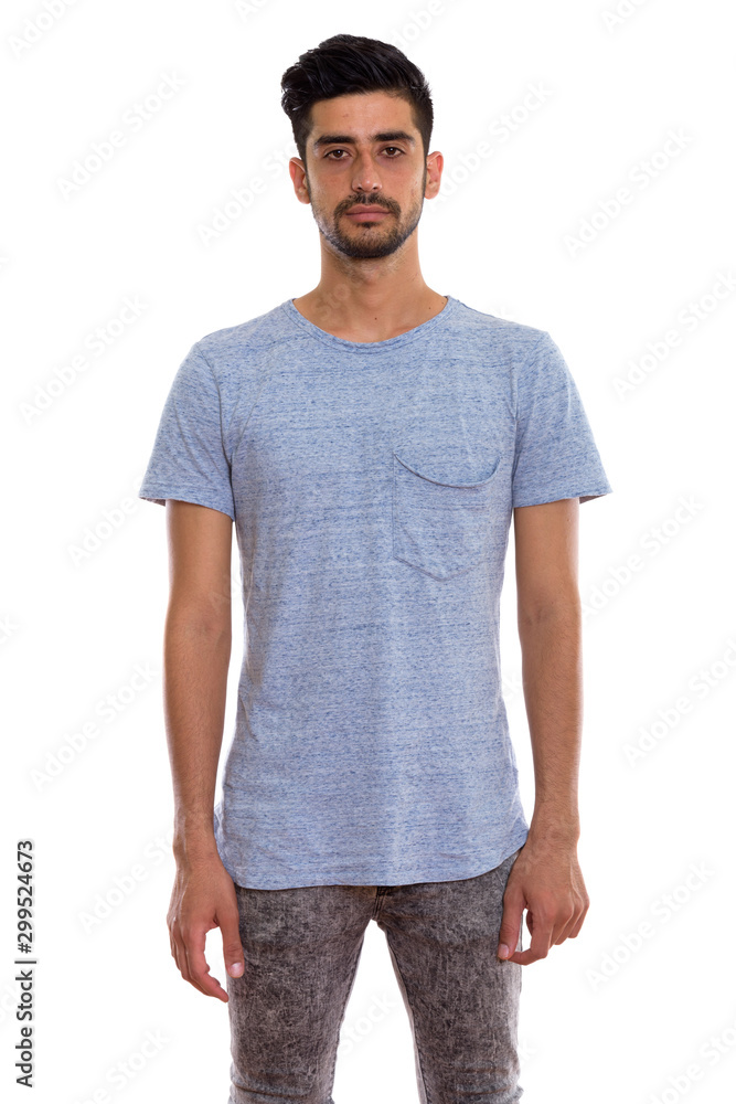 Studio shot of young Persian man standing Studio shot of young Persian man standing