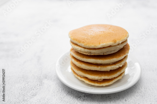 Pile of american clasic pancakes breakfast or snack, isolated on white background, copy space for text.