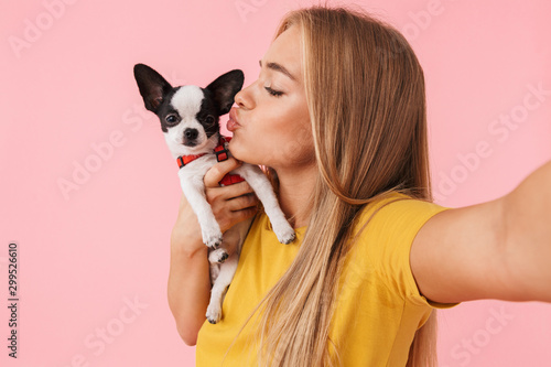Cute lovely girl playing with her pet chihuahua