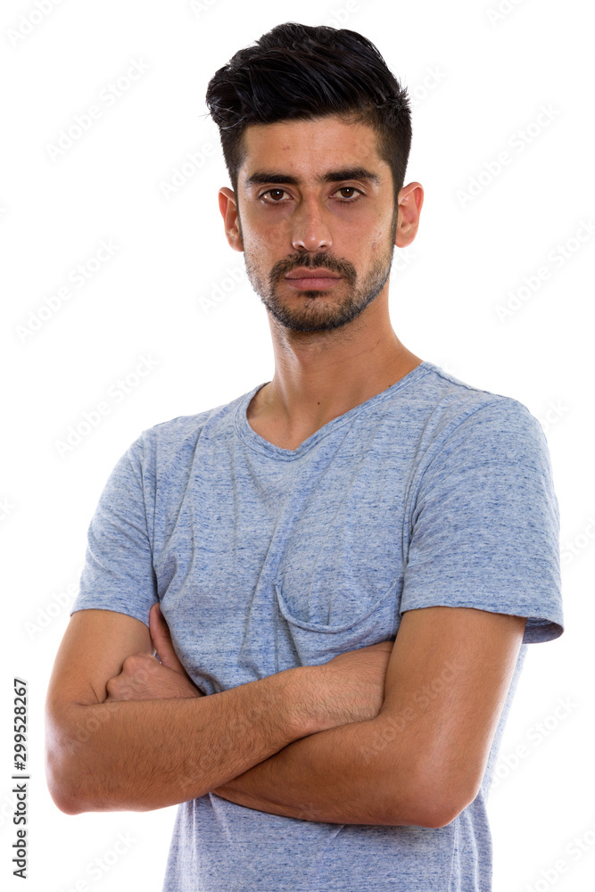 Studio shot of young Persian man with arms crossed Studio shot of young Persian man with arms crossed
