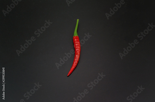 Red chilli on black background using fresh red. It has spicy., food concept., Top view. Pepper isolated on black background. Food for health.