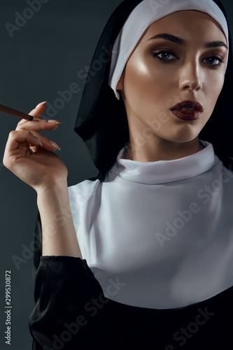 Cuadro en lienzo Close-up portrait of a nun, taking on a black background
