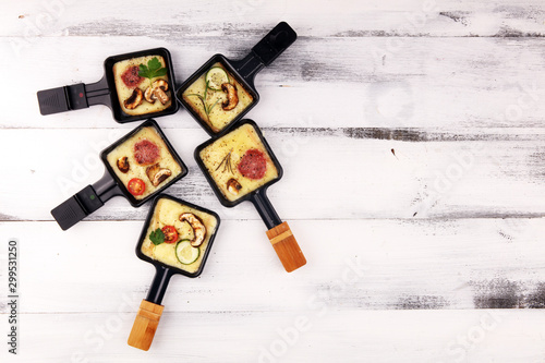 Canvas Print Delicious traditional Swiss melted raclette cheese on diced boiled or baked potato