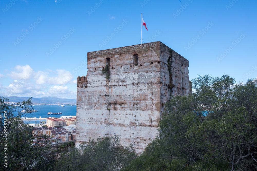 Military keep with flag and stone construction overlooking the sea