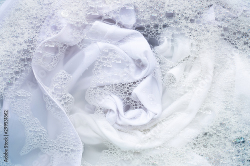 Valokuvatapetti Soak white clothes in powder detergent water dissolution