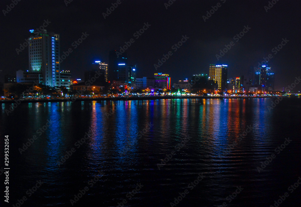 Da Nang city of Vietnam illuminated at night and reflected in Han river 
