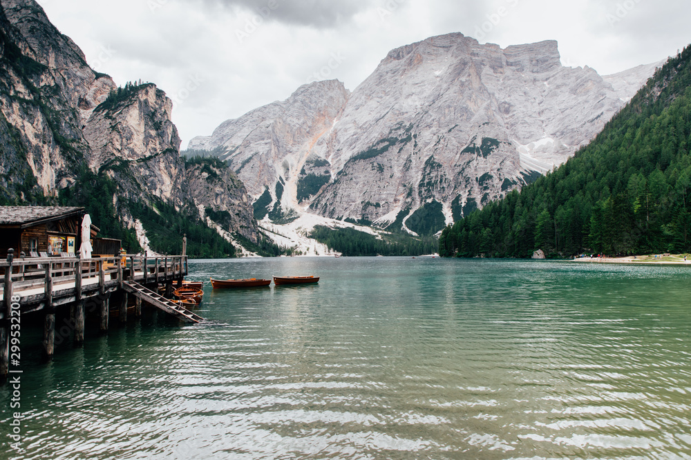 Dolomites, Italy - July, 2019: Spectacular romantic place with typical wooden boats on the alpine lake, Braies lake,Dolomites,South Tyrol,Italy,Europe