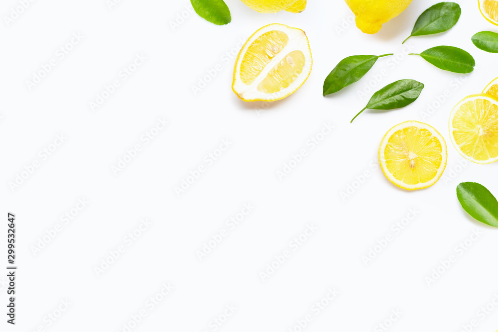 Fresh lemon with green leaves on white.
