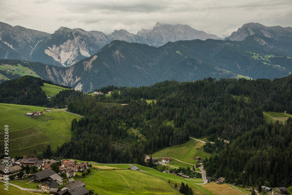 Dolomites, Italy - July, 2019: Small houses and big dolomite mountains valley.