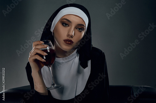 Photography Portrait shot of a nun, taking on a black background