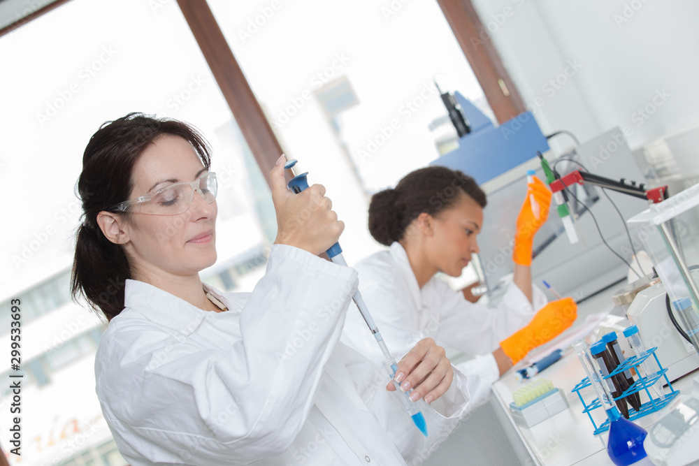 two young female scientist doing experiments in lab two young female scientist doing experiments in lab